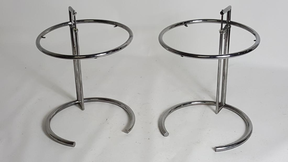 Pair of Eileen Gray Chrome Side Tables: Pair of chrome Eileen Gray tables having circular form and chain detail. Style is E-1027. Without glass tops. 24.5 inches height, 20 inches diameter. 24.5"H x 20"W x 20"D Without tops