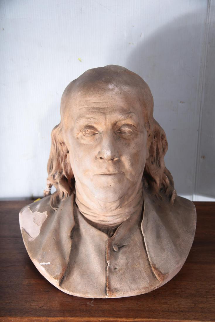 Bust of Benjamin Franklin: Plaster bust depicting Benjamin Franklin wearing a suit. Wood block base. 13 inches height, 13 inches width, 10 inches depth. 13"H x 13"W x 10"D
