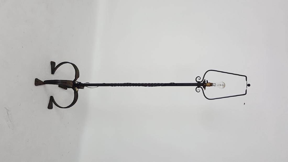 Wrought Iron Floor Lamp: Black wrought iron floor lamp having 4 curved legs to base and twisted post. No shade. 66.5 inches height, 16 inches diameter. 66.5"H x 16" diameter Light wear from age and use