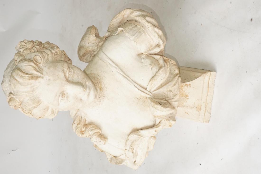 Plaster Bust of a Woman: Plaster bust of a woman in 18th century fashion with light brown colored detail. Wear from age and use. 27.5 inches height, 20 inches width, 7 inches depth. 27.5"H x 20"W x 7"D Wear from age and use