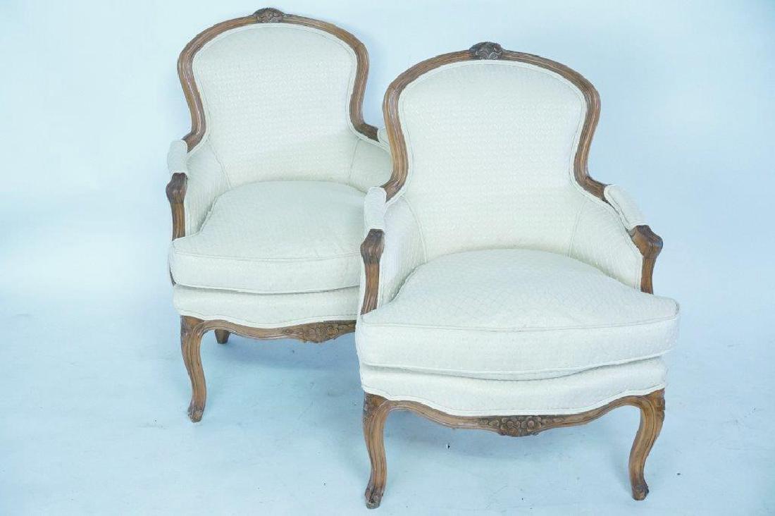 Pair Creme Fabric French Bergeres: 20th century. Louis XV style bergeres with fruitwood frames and creme upholstery.