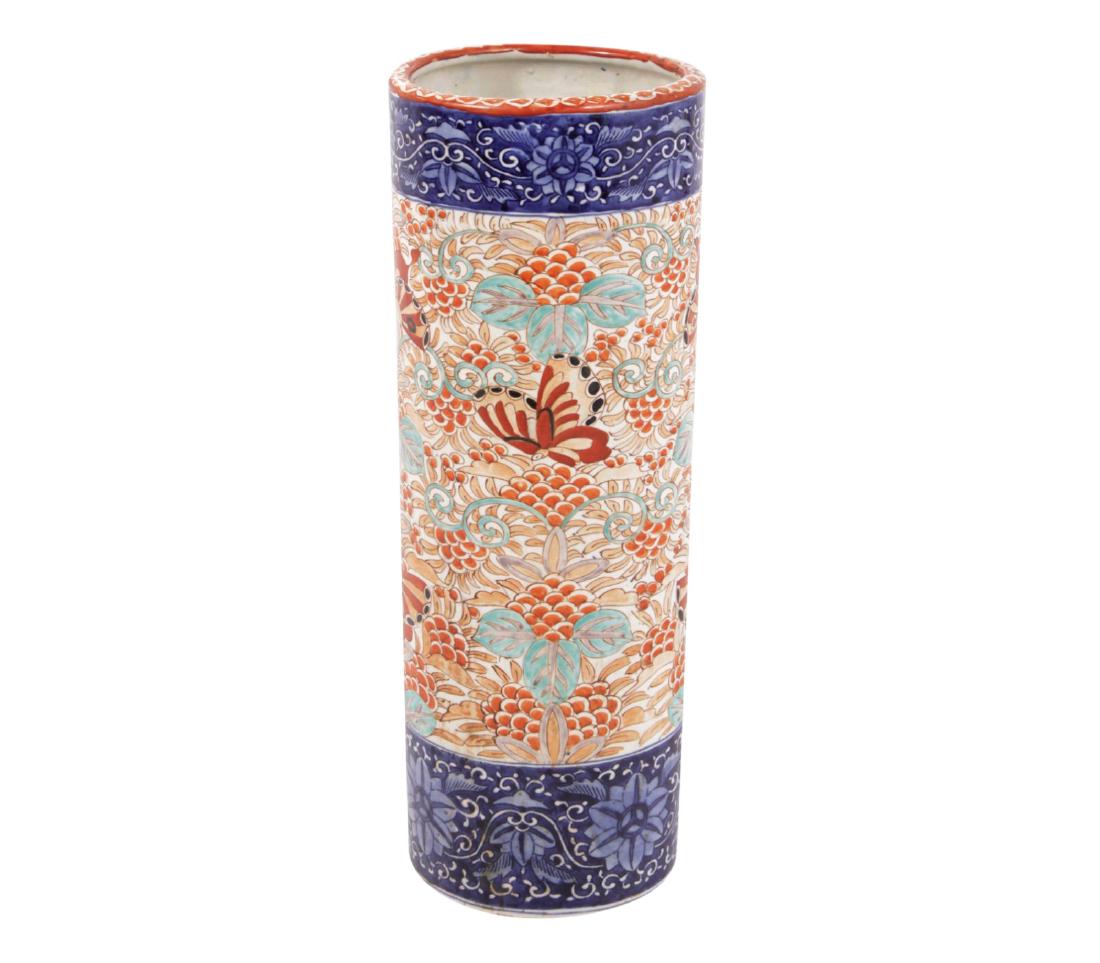 Imari Umbrella Stand: Probably early 20th. Of cylindrical form, with upper band of cobalt blue, and butterfly and foliage decoration in an iron red palette. 24.5 inched height, 9 inches diameter. 24.5"H x 9"Dia