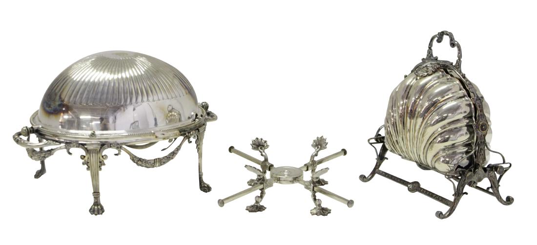 Two Silver Plate Bun Warmers: One, a neoclassical Oval Silver Plate Covered Bun Warmer on Footed Base..Missing bone insulator The other, of clam shell form. Together with folding stand. Condition commensurate with age and use. 10"