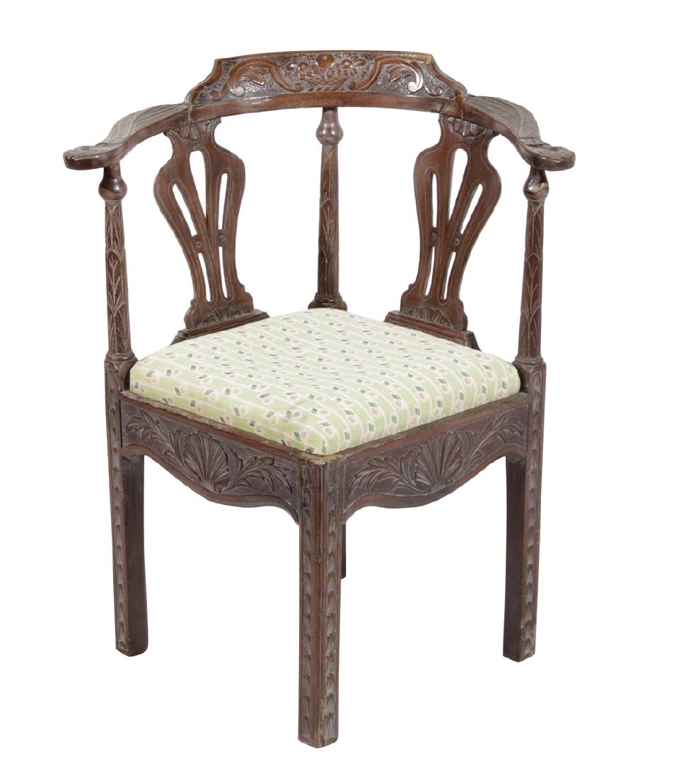 Carved Corner Chair: With carved and stylized panels. Condition commensurate with age and use. 32.5"H x 27"W x 24"D