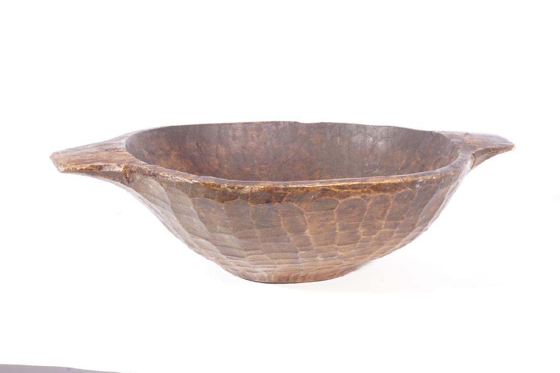 Antique Wooden Bowl: The exterior with chisel marks, handles to the sides. Deterioration to inside of bowl. 5"H x 18"W x 12"D