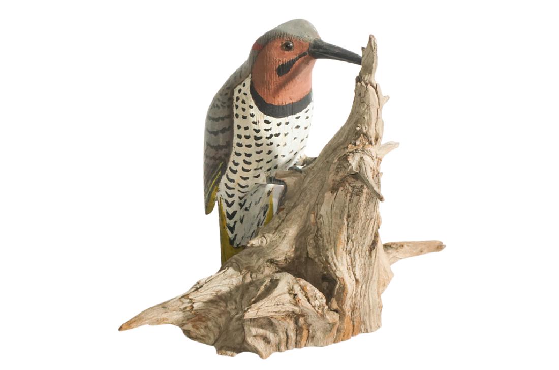 Model of a Woodpecker: Ornately carved and painted model, mounted to side of a tree. Signed indistinctly to underside, date 1974. 8" x 8" x 5"