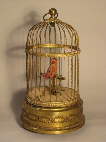 SINGING ARTICULATED CAGED ROBIN:: A mechanical singing bird in a brass cage. Mechanical wind on underside.