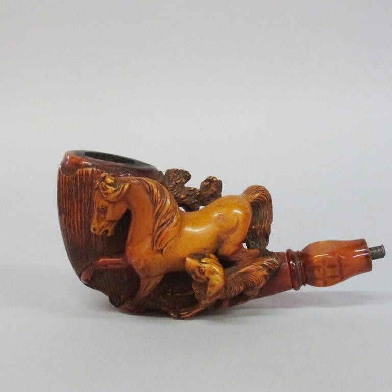 THREE CARVED PIPES: Each carved in a horse theme. One carved in a high relief horse and hunting dog motif. Two with mother of pearl inlaid stems. Note: All three are lacking stems. Provenance: A fine Cumming, Georgia hom
