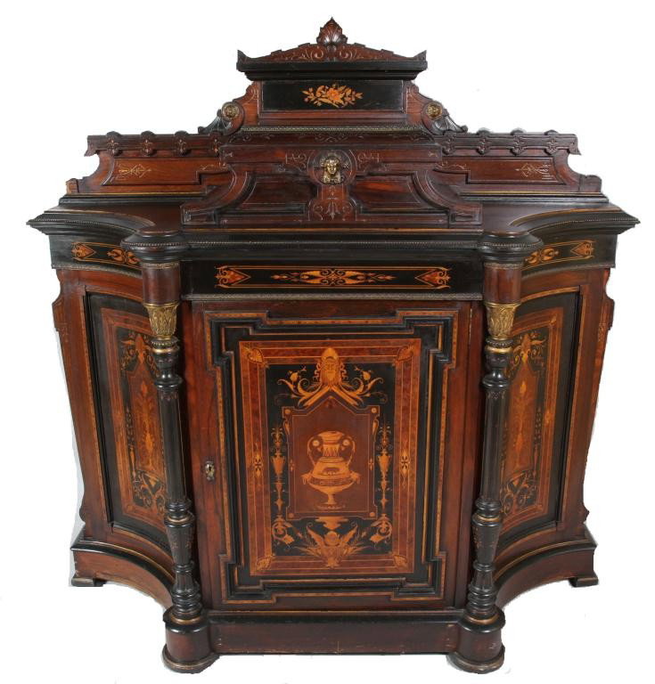 AMERICAN VICTORIAN INLAID & EBONIZED CABINET:: Possibly Pottier & Stymus. Having fine marquetry inlay in classical urn motif. The base fitted with a center door between two concave panels and accentuated columns with gilt bronze capitals. Surmount
