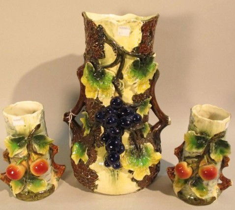 AUSTRIAN AMPHORA SET: 19th century. A 3 piece amphora set consisting of a pitcher and two cups hand painted and molded with high relief peaches, grape bunches, and vines. Stamped and numbered "4789" on underside.