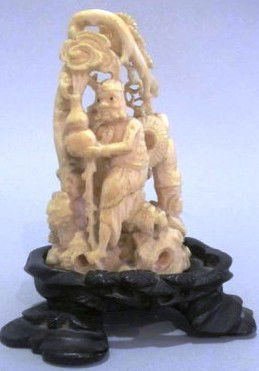 CARVED CHINESE IVORY FIGURAL GROUP: An intricately pierce carved fishing scene consisting of two figures with a large fish. Accompanied with a wood base. Ivory measures 3.25"H Provenance: A fine Buckhead residence