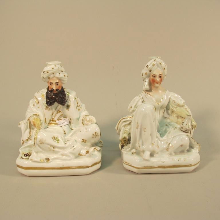 PAIR OLD PARIS PORCELAIN SCENT BOTTLES: White glazed figures modeled in the manner of Jacob Petit. The figures in the forms of a seated Middle Eastern man and woman in robes and turbans. 19th century. Bearing blue "j.p." marks on undersides