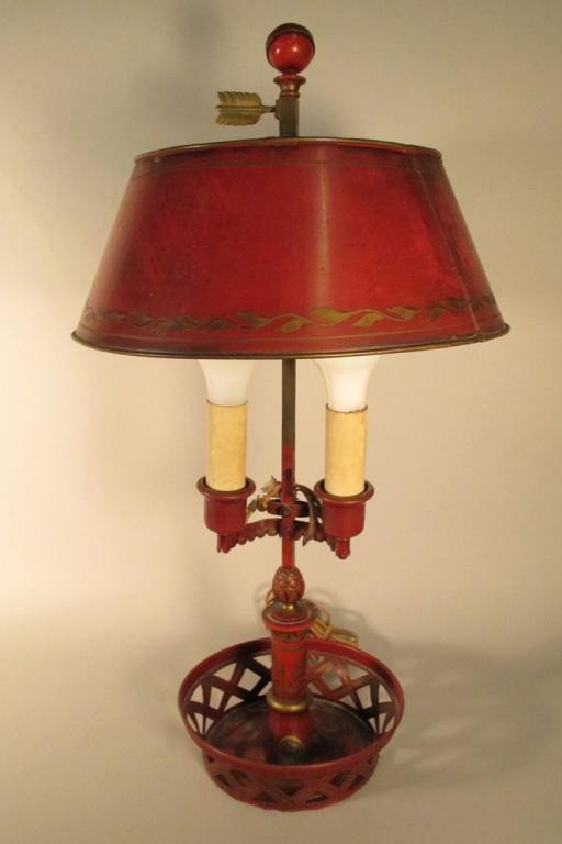 RED TOLE LAMP: An antique hand painted two light tole lamp in a reticulated base. 26"H Provenance: From a fine Buckhead home