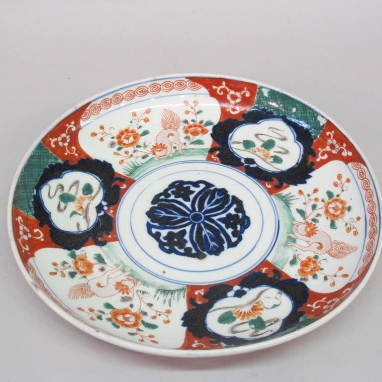 IMARI SHALLOW BOWL:: A circular shallow bowl hand painted with animals and floral motif in the imari palette. Blue glaze character marks on verso. Note: Chips to rim. Provenance: The Ferst estate