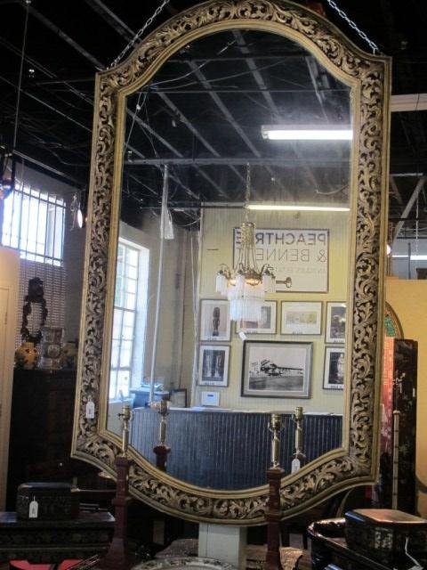 VERY LARGE ITALIAN HAND CARVED GILT MIRROR:: 19th century. A massive pierce carved and gilt framed mirror in a scrolling acanthus leaves motif. Some gilt loss to edges, and aged silvering. 91" X 53"