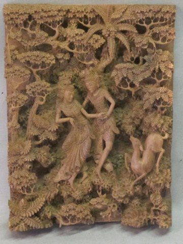 FINELY CARVED TIBETAN WALL HANGING:: A highly detailed wooden carving depicting two figures and a deer among trees and foliage. 19"H X 14.5"W
