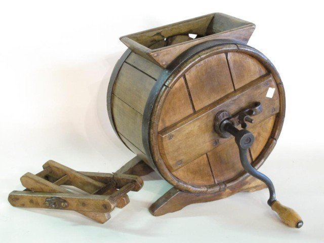 ANTIQUE WOODEN BUTTER CHURN:: A drum form antique wooden butter churn with iron turning handle. 16"H X 12.5"W