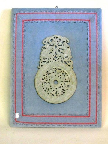 CARVED CHINESE JADE PLAQUE: A finely carved white jade plaque in openwork, in the form of birds and scrolling foliates supporting a large circle. Mounted on a light blue velvet covered board. Jade measures 11"H. 19"H X 14"W, ove