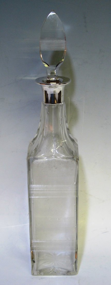 MAPPIN & WEBB SILVER COLLAR CRYSTAL DECANTER: A tall crystal decanter with etched banding. The silver collar stamped with hallmarks and "Mappin & Webb". Note: Chip to the tip of the crystal stopper. 15.5"H