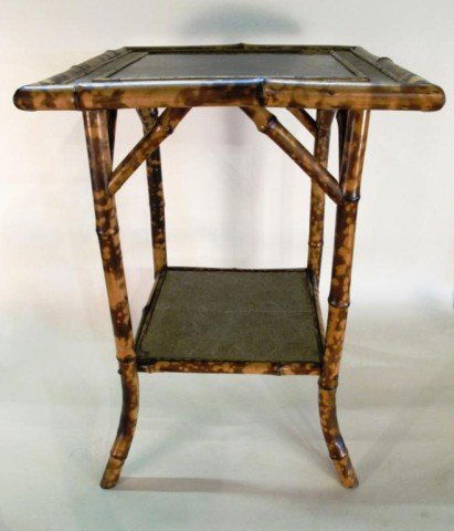 TWO TIER BAMBOO TABLE: A square table with black panel insert and gilt chinoiserie bird decoration. 29"H X 20.5"W