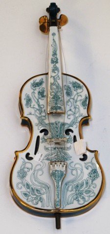SZASZ ENDRE FULL SIZE PORCELAIN VIOLIN:: 20th century. Modern Hungarian green and white glazed porcelain full size violin with parcel gilt decoration. Note: Modern tree of life decoration on verso. 23"L Manufactured by Hollohaza.