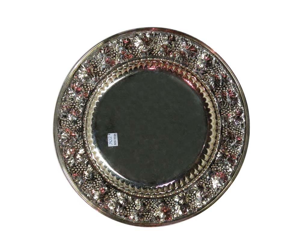 BUCCELLATI CIRCULAR REPOUSSE TRAY: A circular tray with a heavily embossed rim in grapes and leaves motif, the center bordered with egg and dart decoration. Marked on underside "Buccellati" and "Sterling" on underisde.12.5" in diameter