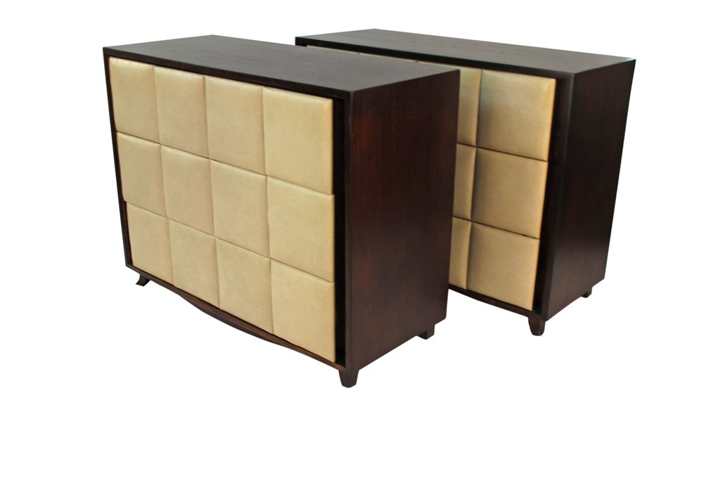 PAIR GILBERT ROHDE FOR HERMAN MILLER CHESTS: 1930s. Iconic padded naugahyde pair of dressers by Gilbert Rohde for Herman Miller. Ebonized mahogany with original ivory colored naugahyde. Very good condition. 34.5"H X 18.5"D X 44.5"W