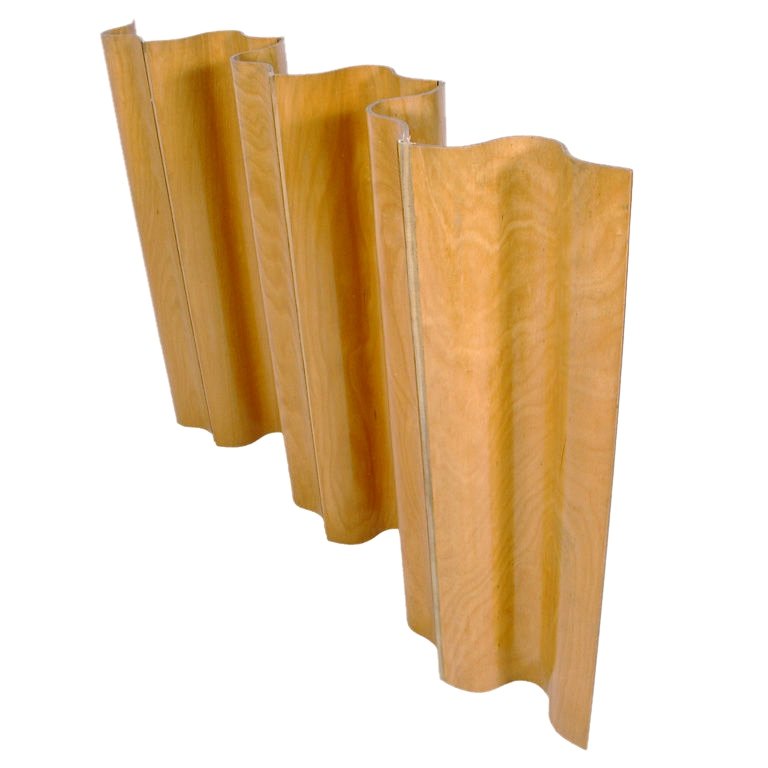 EAMES FOLDING SCREEN:: Circa 1952. By Charles and Ray Eames, manufactured by Herman Miller. A half screen of six molded birch plywood sections with canvas hinges. The rare half height screen was first offered in 1952, and p
