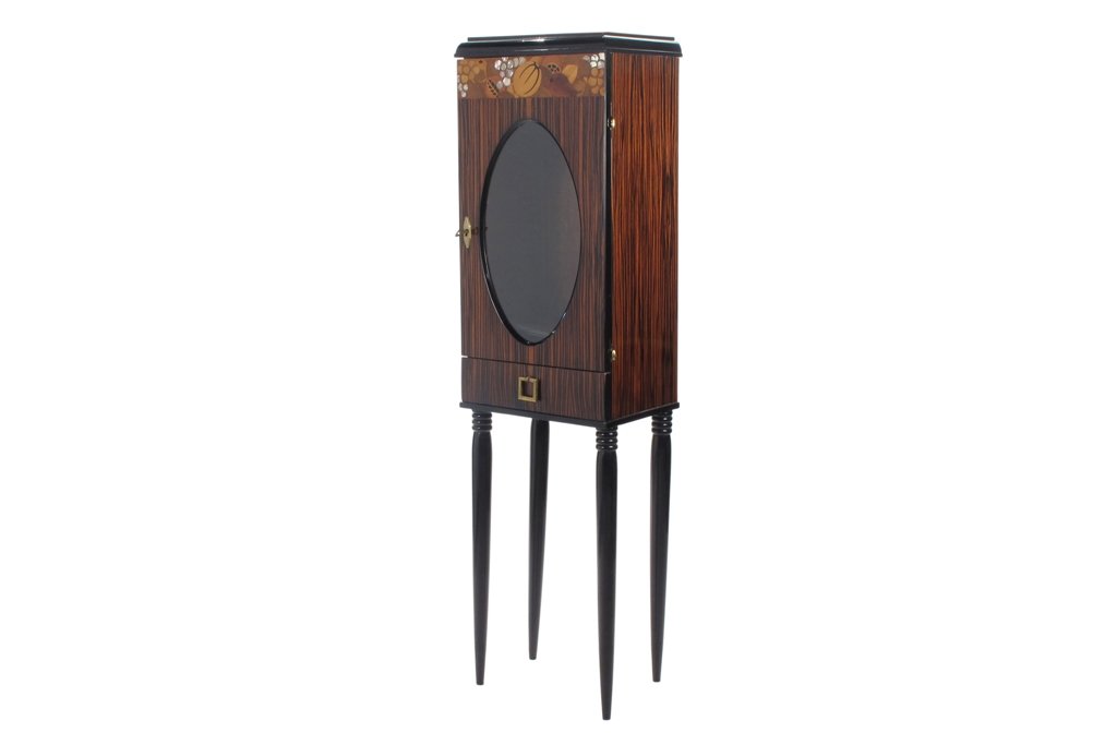 PAUL IRIBE (FRENCH,1883-1935): Art Deco cabinet on stand designed by Paul Iribe, French illustrator and designer of decorative arts. The upper cabinet veneered in palisander wood, featuring marquetry and mother of pearl inlay depic