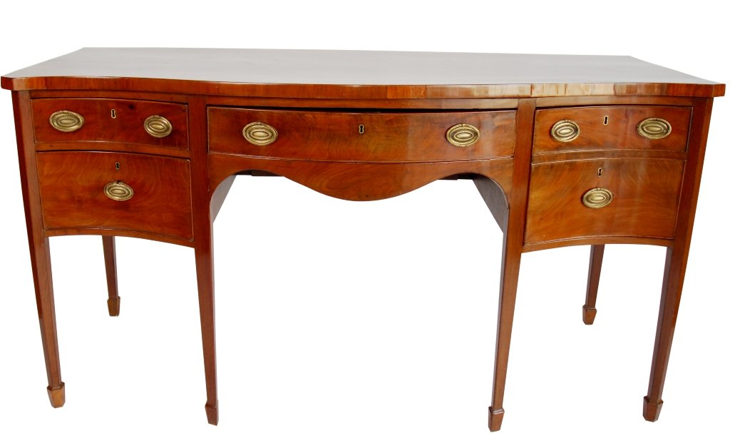 ANTIQUE GEORGIAN MAHOGANY SIDEBOARD:: A serpentine front mahogany sideboard fitted with a central drawer flanked by two drawers to the left and one deep drawer to the right. All raised on Sheraton style legs with spade feet. Very good con