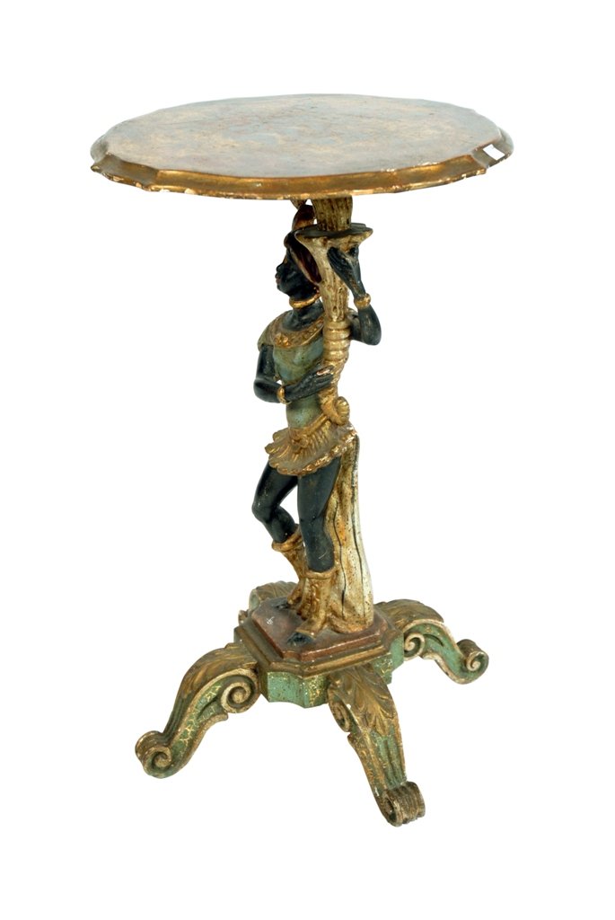 ANTIQUE CARVED & PAINTED BLACKAMOOR STAND:: A carved, polychromed and parcel gilt wood table in the form of a female holding a cornucopia supporting the table surface. Raised on a base of four carved scrolling feet. 27.75"H X 17" diameter.