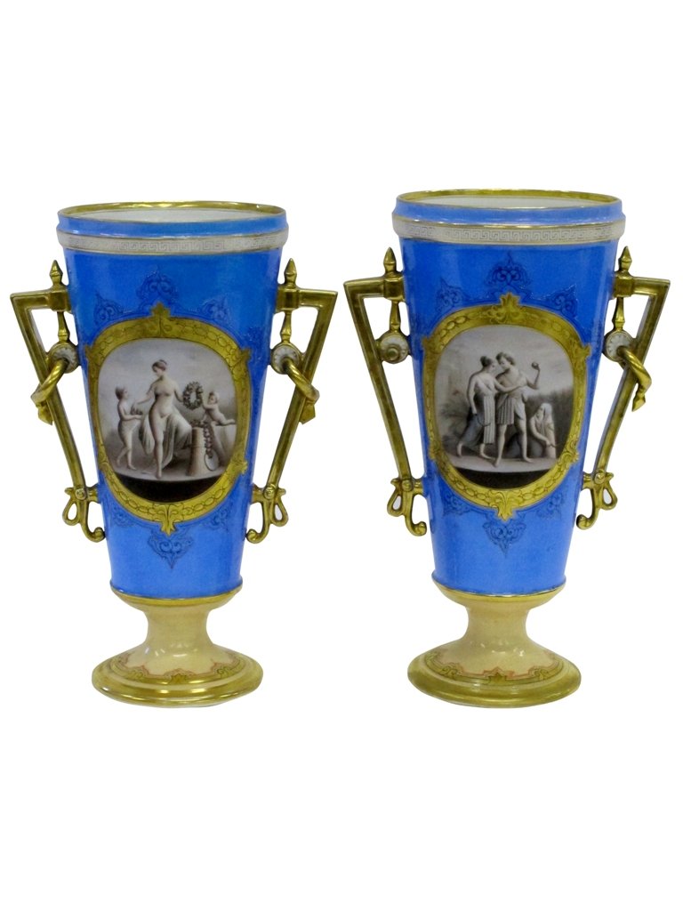PAIR ANTIQUE FRENCH PORCELAIN VASES: Late 19th century. Tall tapering light blue vases, with hand painted figural cartouches in grey tones. One depicts a scene of wheat harvesters, the other a scene of Venus with two putti. Both vases ha