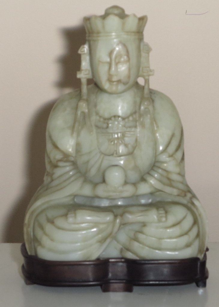 JADE FIGURE OF KUAN YIN: Antique Chinese Mutton Fat Jade Figure of the seated Goddess, her high coifed hair with top knot fitted with a tiara with flanged and tasseled pendants, wearing a beaded necklace and bow - knotted rib