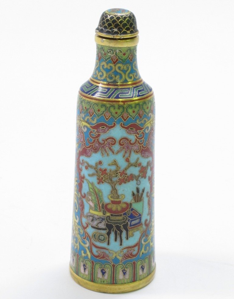 CLOISONNE SNUFF BOTTLE:: Tapering cylindrical bottle form decorated with various oriental vessels and featuring a bonsai tree in an oriental vase. 3.75"H character marks to base