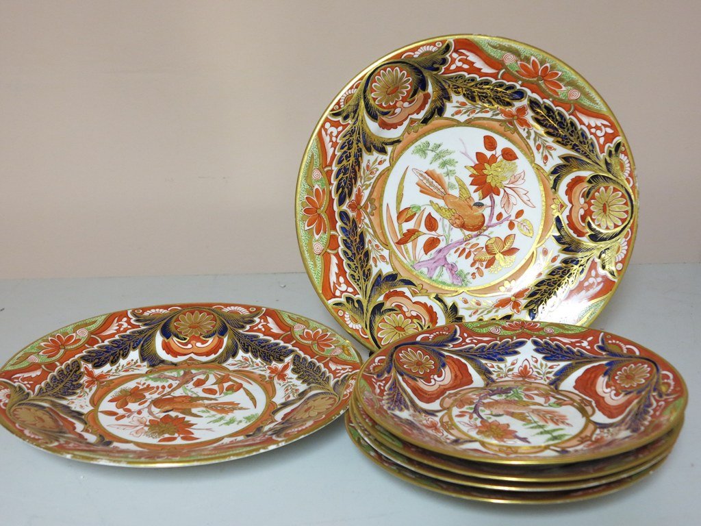 GROUP OF ANTIQUE CROWN DERBY IMARI PORCELAINS: A group of six pieces of early 19th Century English Crown Derby Imari patterned porcelains. Comprised of two dinner plates and four matching dessert plates. Each having a center bird medallion in a fl
