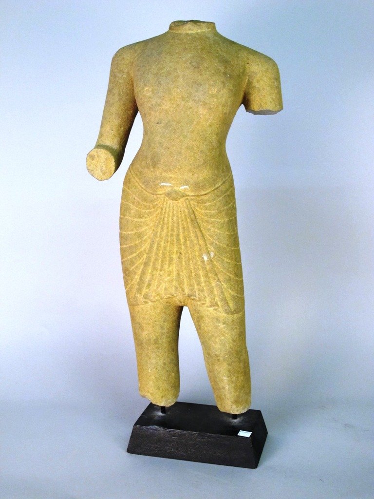 EGYPTIAN CARVED STONE FIGURE:: An Egyptian Carved Stone Figure, possibly ancient, arms at side, lacking head and feet situated on a rectangular base. Approximately 28"H. Provenance: Madison Museum of Fine Art