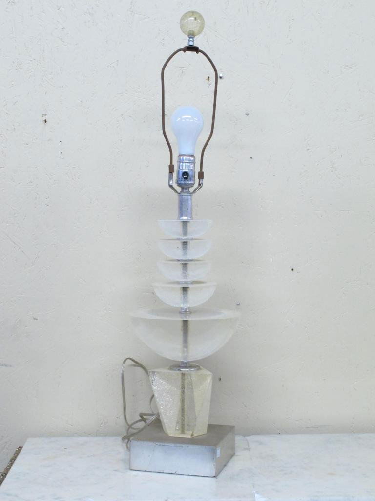 A LUCITE TABLE LAMP, VAN TEAL, CIRCA 1970S:: Having a chrome standard with five tiered Lucite semi spheres above a polygonal base, raised on a square chrome base.