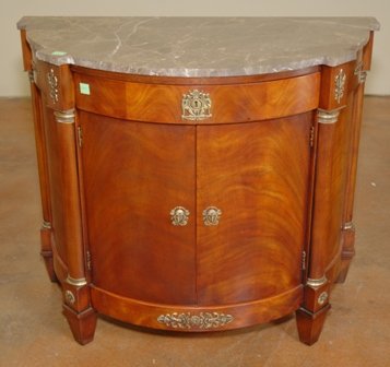 EMPIRE STYLE DEMILUNE FLAME MAHOGANY COMMODE:: Henredon Natchez Collection, having a marble demilune top set on a conforming case fitted with a single drawer over two doors, raised on squat tapered legs. Overall good stable condition with no appar
