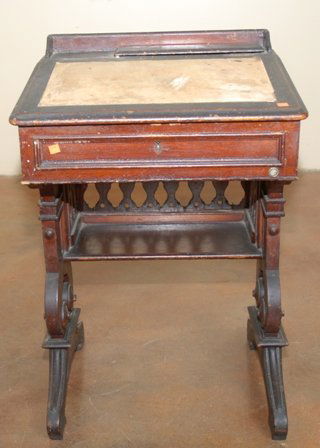 AN AMERICAN HOUSE OF REPRESENTATIVES WALNUT DESK:: the desk of typical form having a rectangular slant front with leather insert, over the conforming case, raised on carved legs joined by a medial shelf. The desk with embossed plate attributing the de