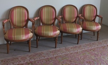 A SET OF FOUR LOUIS XVI FAUTEUIL:: 18th century, beech wood on cylindrical tapering fluted legs. Striped upholstery. Provenance: From a fine private Manhattan residence of the Pierre Hotel, 2 East 61st Street in New York City.