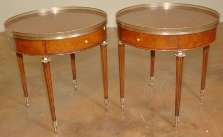 PR EMPIRE STYLE BURLWOOD ENTRY TABLES:: Maitland Smith, each with circular top having a pierced brass gallery above the conforming case with two short drawers, raised on tapered legs ending in brass ormolu feet. Overall good stable conditio