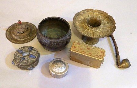 A GROUP OF SEVEN ARTS AND CRAFTS TABLE ARTICLES:: primarily of Middle Eastern origin, comprising a brass pipe, lidded metal container with lapis stones, a white metal lidded circular box , bronze bowl and three others.