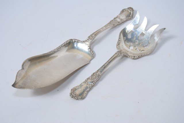 TWO GORHAM SERVING PIECES: A pair of early 20th Century American sterling silver Fish Servers Manufactured by Gorham having raised scrolled water leaf and shell decorated handler. Each stamped sterling with the marker's mark on