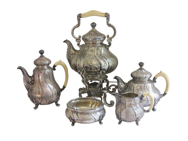 800 SILVER TEA SERVICE: A antique Continental Rococo style five piece 800 silver tea service. Each piece having raised scroll work with a lower engraved acanthus leaf decoration. All stamped 800 with marker's marks on bottom