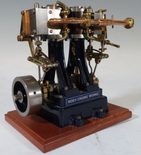 WORKING SCALE MODEL ROBY ENGINE: Hand milled constructed by Carl Roby to scale in brass, aluminum and steel. Two cylinder in dark green enamel paint on mahogany base. 6 1/2"H X 7"W X 4 1/2"D. Excellent condition.