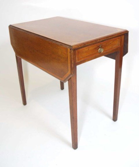 A SHERATON MAHOGANY PEMBROKE TABLE: Of faded color, the leaves with chamfered corners and inlaid with satinwood and stringing, the centre with fan inlay at the corners, fitted at one end with a drawer, supported on square tapered legs. 