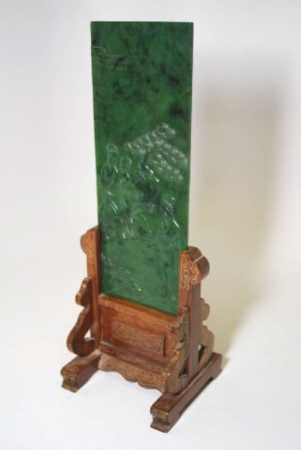 CHINESE SPINACH JADE TABLE SCREEN: The rectangular carved spinach jade panel depicting a Lady in a landscape with two attendants. The whole mounted on a custom brass wire inlaid rosewood base. Screen 10 3/8" H X 4" W With Base 14" H No