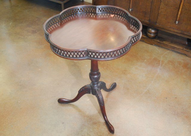 MAHOGANY TEA TABLE WITH PIERCED GALLERY: On three carved legs 27 1/2"H X 22" Dia. top