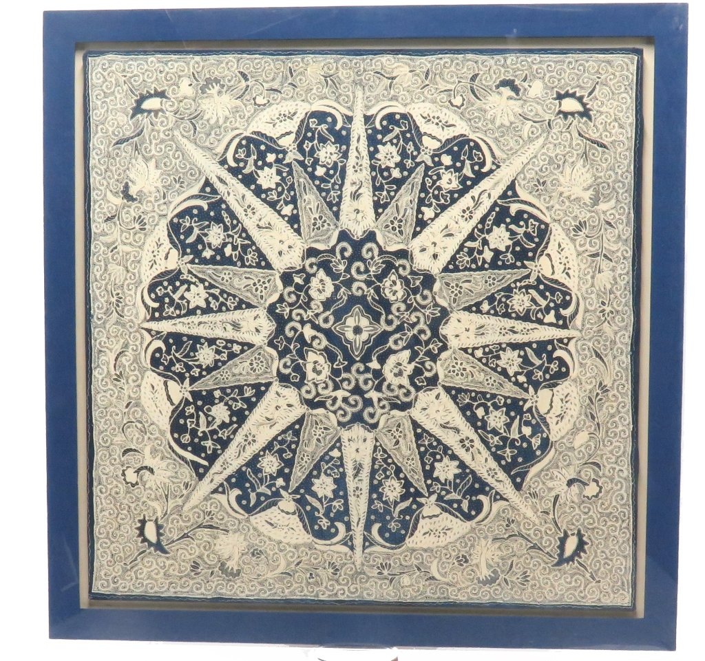 FRAMED PANEL: A large framed blue and white India Batik cotton panel Depicting a sunburst with allover flowering vine decoration. Unsigned. Mounted in an acrylic shadow box frame. Measures: 48" H x 48" W. PROVENANC