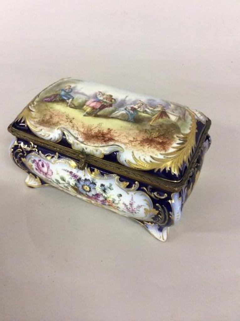 FRENCH PROCELAIN DRESSER BOX: Decorated with genre scene and overall floral decorations. Bears several marks to the base. 12"L X 8"W X 6"H.
